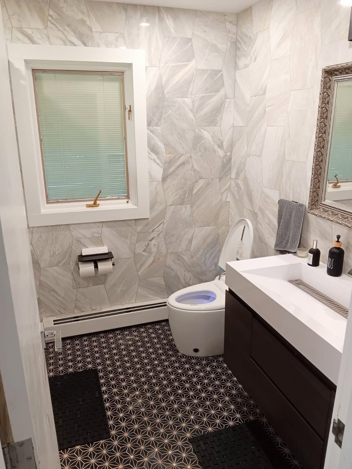 Completed bathroom renovation with marble tile