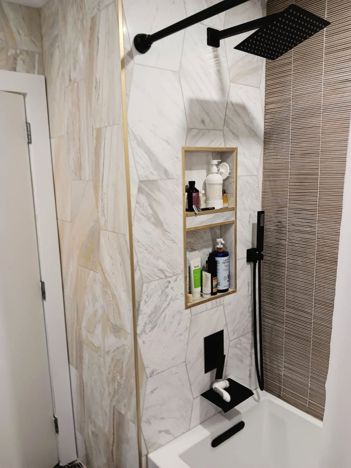 Completed tiled shower with black fixtures